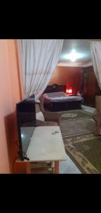 a room with a bed and a table and a couch at شقه مفروش in Cairo