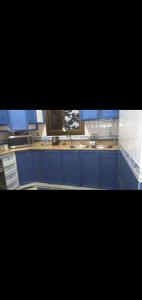 a kitchen with blue cabinets and blue counters at شقه مفروش in Cairo