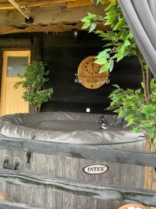 a hot tub in front of a house with a door at KUĆA ZA ODMOR/PROSLAVE in Lukinić Senovec