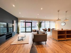 a living room with a couch and a table at Lovely two bed apartment in Finnieston in Glasgow