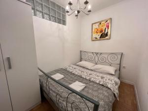 a small bedroom with a bed in a room at Apartments Flores in Zagreb