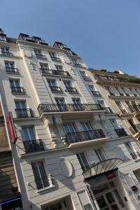 a white building with balconies on the side of it at Mercure Paris Bastille Marais in Paris