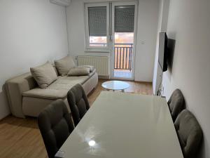 a living room with a couch and a table at HG apartment in Jelah