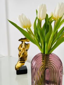 a vase with white flowers in it next to a statue at Corso Venezia in Mestre