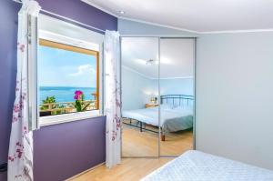 a bedroom with a view of the ocean at Apartment in Crikvenica 27606 in Crikvenica