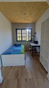 a bedroom with a bed and a desk in a room at Casa Cerro Arco in Mendoza
