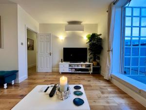 a living room with a candle on a table at A Penthouse by Tower Bridge in London