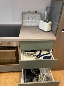 a kitchen counter with a drawer filled with dishes at Dein Haus am Rhein in Koblenz