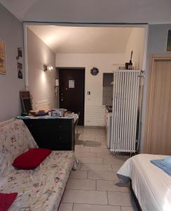 a bedroom with a bed and a room with a radiator at Cinecasa di Andrea e Cristina in Turin