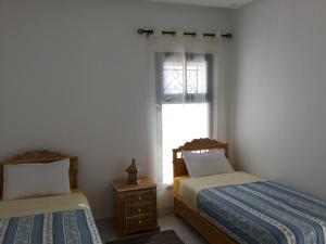 Rúm í herbergi á Marsa Central Splendid Appart 2