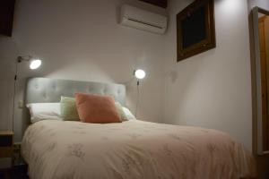 a bedroom with a bed with a pillow on it at Calle de las Bulas - Judería in Toledo