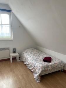 a bedroom with a bed and a window at La Grange Chevrefeuille 