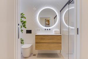 a bathroom with a sink and a mirror at Riazor Deluxe Penthouse in A Coruña