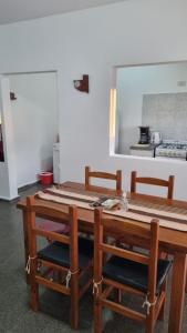 uma cozinha com uma mesa de madeira e 2 cadeiras em Don Roque II em Santa Rosa
