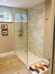 a shower with a glass door in a bathroom at The Folly Bushmills in Bushmills