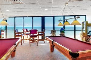 a billiard room with a pool table and chairs at Golden Sands 714 in Ocean City