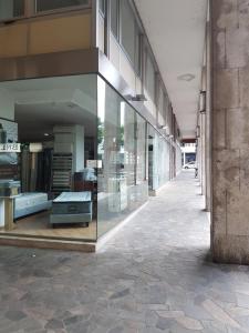 an empty hallway of a building with glass windows at B&B Xenia in Pordenone