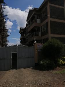 a building with a fence in front of it at NASH ISSAH 1BEDROOM APARTMENTS in Nakuru