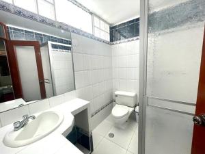 a bathroom with a toilet and a sink and a mirror at Apartamento Sotillo in Ilo
