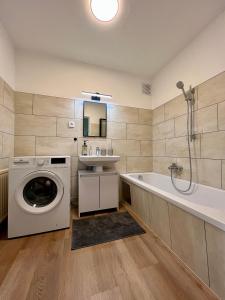 W łazience znajduje się pralka i wanna. w obiekcie Apartment Popular w mieście Dornbirn