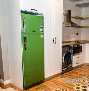 a green refrigerator in a kitchen next to a stove at Sunny Lakes Resort , Revira Apartment in Sharm El Sheikh