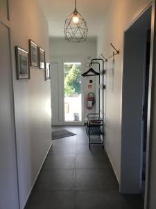 a hallway with white walls and a tile floor at Holiday Apartment 4you in Butgenbach