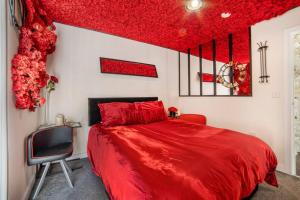 a bedroom with a red bed with a red ceiling at Romance in Leicester City Center in Leicester