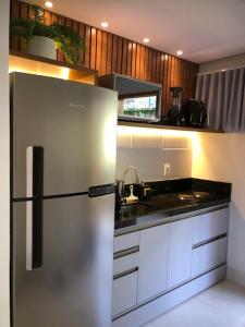 a kitchen with a refrigerator and a sink at Lindo Ap Studio em Bananeiras in Bananeiras