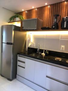 a kitchen with a stainless steel refrigerator and a sink at Lindo Ap Studio em Bananeiras in Bananeiras