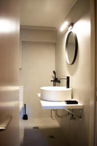 a bathroom with a sink and a mirror at RYB Colour Apartment in Patra