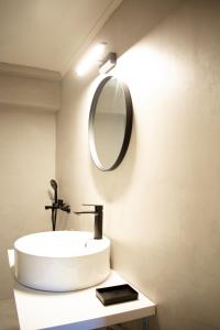 a bathroom with a sink and a mirror on the wall at RYB Colour Apartment in Patra