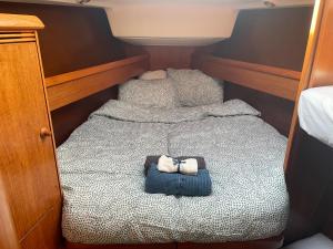 a small bedroom with two beds with jeans on them at Precioso velero en Badalona de 3 camarotes in Badalona