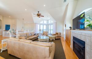 a living room with a couch and a tv at Atlantic Paradise in Southern Shores