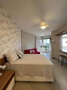 a bedroom with a large bed with a brick wall at Condado Aldeia dos Reis 311 in Mangaratiba +48 photos