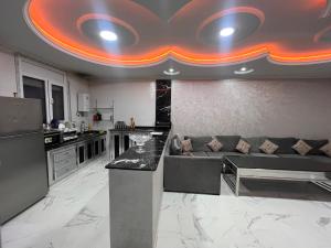 a kitchen and living room with a couch and a counter at Villa Nador in Nador