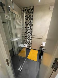 a bathroom with a shower with a glass door at Cozy Apartment - CityCentre - FreeParking - SelfCheck-in in Liptovský Mikuláš