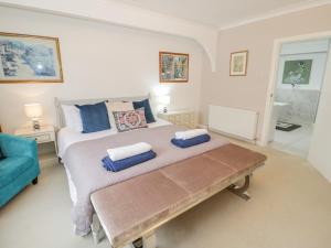 a bedroom with a large bed and a blue couch at Bay Lodge in Amlwch