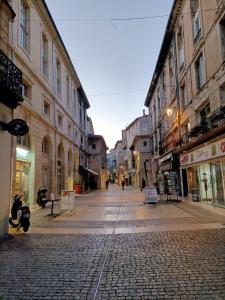 a cobblestone street in a city with buildings at T2-Avignon - centre historique in Avignon