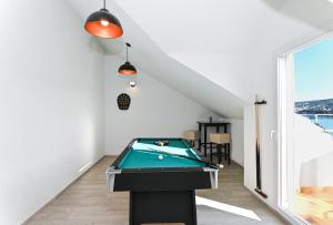 a billiard table in a room with a table at Holiday house Vukman in Trogir