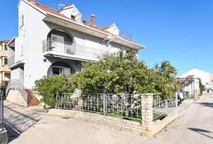 una casa blanca con una valla delante en Holiday house Vukman en Trogir