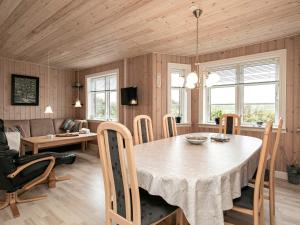 a kitchen and dining room with a table and chairs at Holiday home Lemvig IV in Ferring