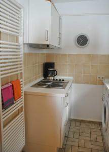 a small kitchen with a stove and a microwave at Ferienwohnung Fischer in Meersburg