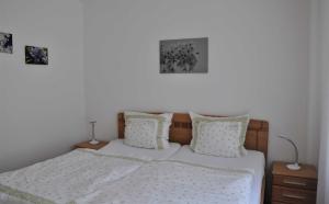 a bedroom with a bed with two pictures on the wall at Ferienwohnung Fischer in Meersburg