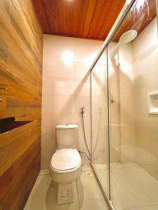 a bathroom with a toilet and a shower at Gadhega's Hotel in Salvador
