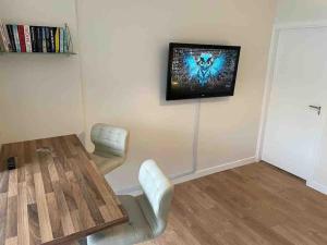 a room with a table and a tv on the wall at Beautiful one bedroom Apartment In Galway City in Galway