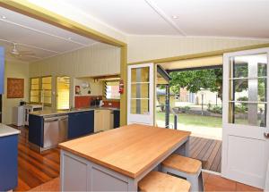 a kitchen with a wooden table and a counter top at Torquay Treasure in Torquay