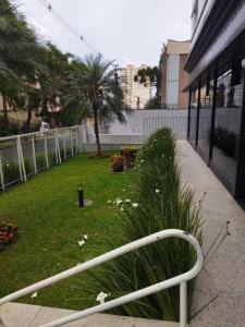 a white railing in front of a yard at Century Hall in Curitiba