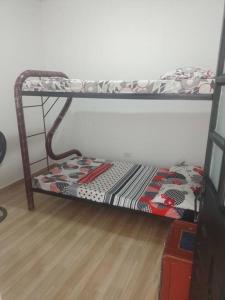 a bunk bed in a room with a wooden floor at casa turística Mónaco 48 in Carmen de Apicalá