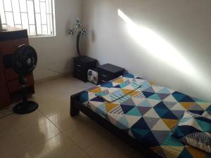 a bedroom with a bed and a fan in a room at casa turística Mónaco 48 in Carmen de Apicalá