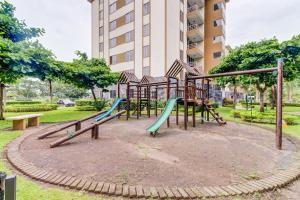 a playground in a park in front of a building at Costa Linda 2-28 in Jacó